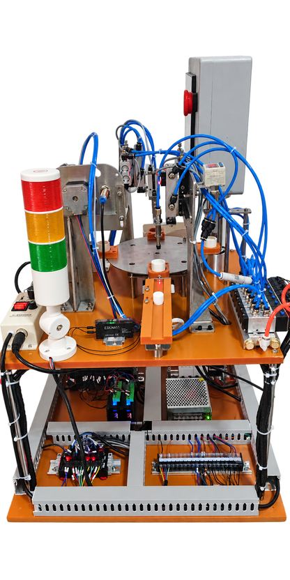 Rear view of rotary assembly trainer showing pneumatic valves, sensors and electrical layout; PLC configuration varies